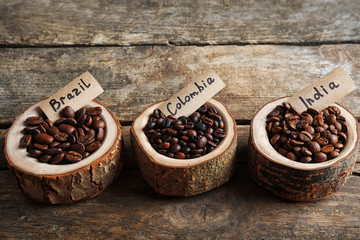 Collection of coffee beans on old wooden table, close up