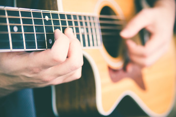 Young man playing guitar. Music, instrument education and learning concept