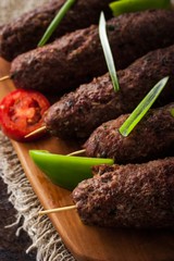 Kebabs with vegetables on the rustic table  vertical
