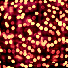 Abstract dark red background with gold circles. Sparkling bokeh