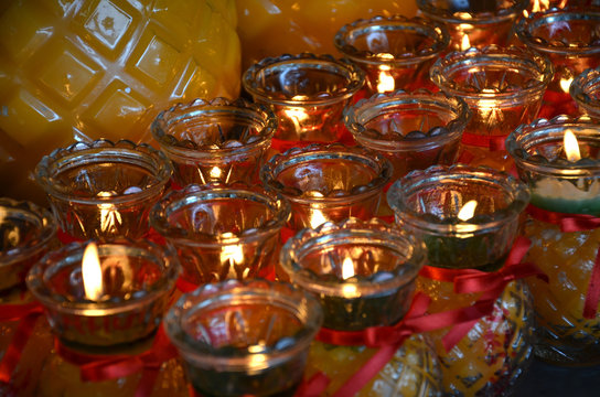Temple candles in transparent chandeliers