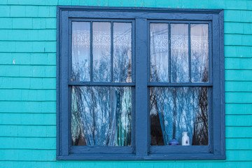 colourful window with curtains and reflection by the Nova Scotia coast