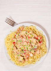 Sliced fried chicken fillet in a creamy sauce. with capellini pasta