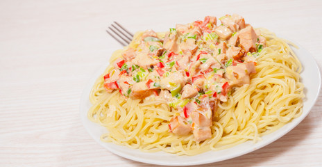 Sliced fried chicken fillet in a creamy sauce. with capellini pasta