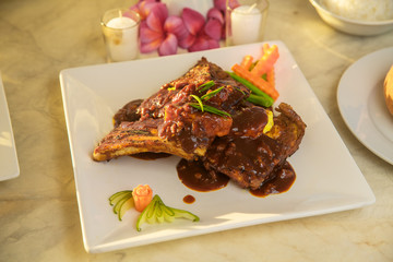 Table with food and drink for romantic dinner on sunset