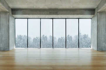 Modern lofty interior with large windows with snow and tree view