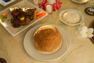 Table with food and drink for romantic dinner on sunset