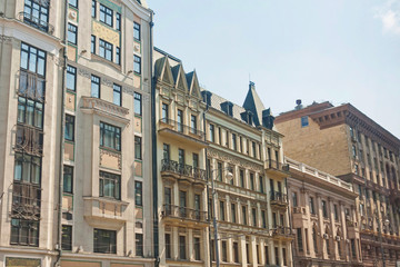 Building façades with stucco molding and bars balconies. Moscow, Russia. 
