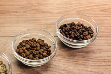 Coffee beans of different roasting in glass bowl