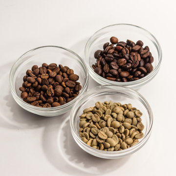 Three types of coffee in glass shelves placed in a triangle on a
