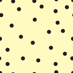 Vector seamless pattern with small black polka dots on the soft yellow background. 
