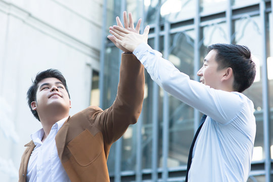 Young Diverse Asian Business Men Giving High Five