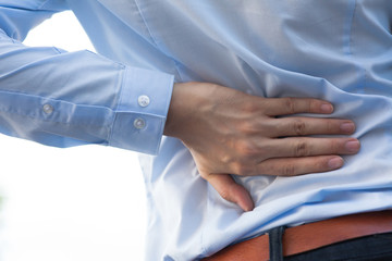 Man in office uniform having back pain issue / back injury