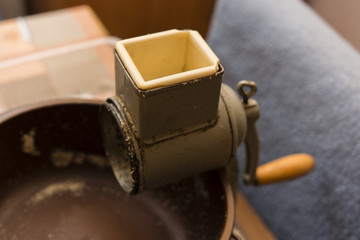 Old grinder with a bowl of nuts