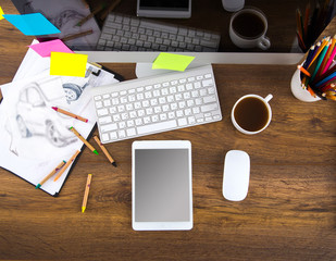 Modern office workplace with digital tablet, notepad, colorful pencils, glasses, in morning