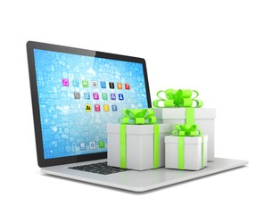Gift box with ribbon bow on laptop keyboard