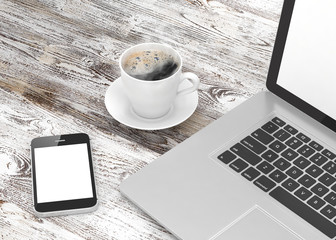 Fototapeta na wymiar Laptop smartphone and coffee cup on wood table