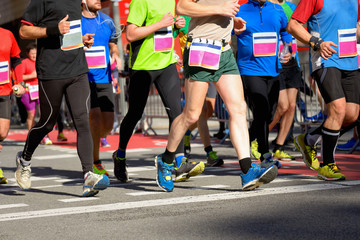Marathon running race, runners feet on road, sport, fitness and healthy lifestyle concept
