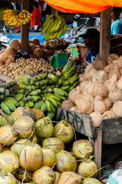 Vendor Selling Coconuts and Green Bananas at local market in Indonesia