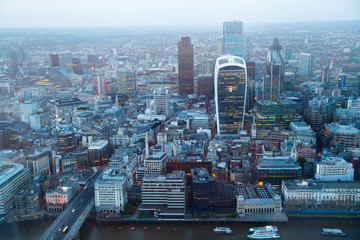 LONDON, UK - APRIL 15, 2015: City of London panorama at sunset. First lights of famous skyscrapers in financial aria