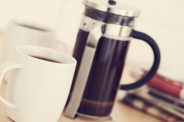 Cups of coffee and newspaper on table