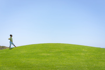 Kid jumping on beautiful field