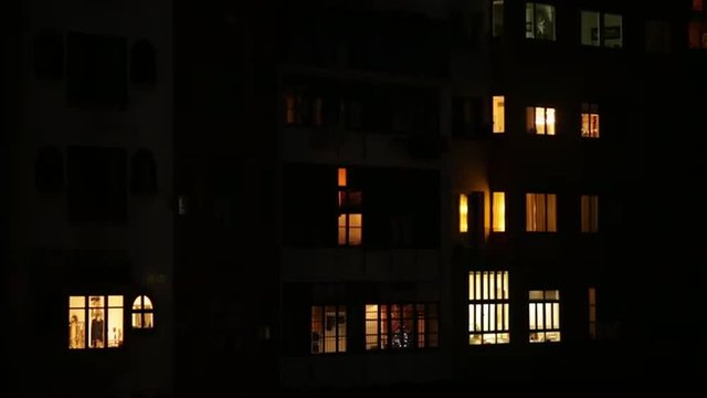 Iluminated window in a city building at night.