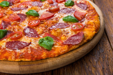 Delicious pizza with salami and cherry tomatoes