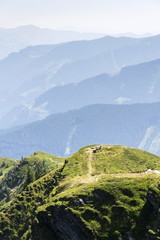 Wooden bench with idyllic summer Alps mountains landscape in Austria, Saalbach-Hinterglemm