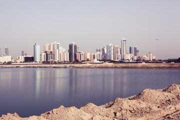 View of the arabian city from the sea with reflection, Bahrain 