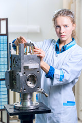 Woman engineer with a caliper measuring device in the modern lab
