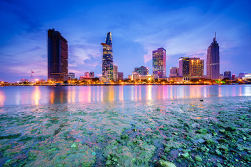 Night view of Business and Administrative Center of Ho Chi Minh city on Saigon riverbank in twilight, Vietnam. Ho Chi Minh city (aka Saigon) is the largest city and economic center in Vietnam.