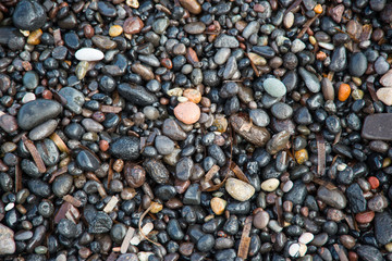 Wet stones on the beach at Kamari on the Greek island of Santorini