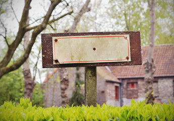 Vintage grunge sign in a small village