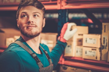 Worker on a automotive spare parts warehouse