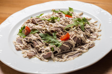 Salad with vegetables, meat on a  plate