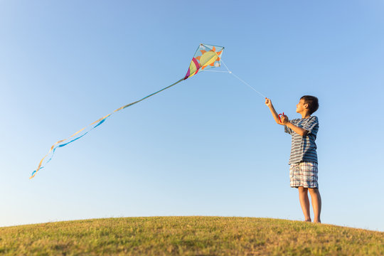 Running with kite on summer holiday vacation, perfect meadow and