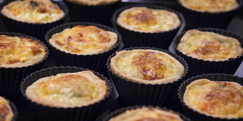 Mini quiche Lorraine - traditional French pie with ham, leeks, b
