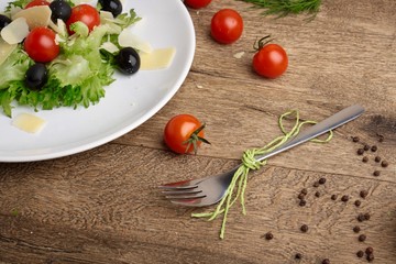 Fresh vegetables salad with tomatoes , olives , parmesan cheese