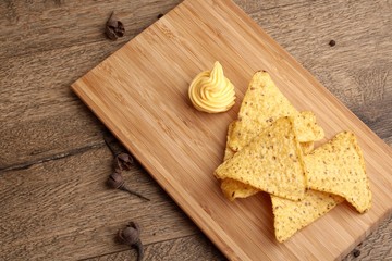 Cheese Sauce with Nachos on wooden background