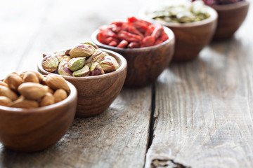 Variety of nuts and dried fruits in small bowls