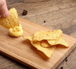 Cheese Sauce with Nachos on wooden background
