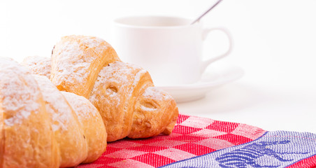 Hot cappuccino and pastries on white wooden boards