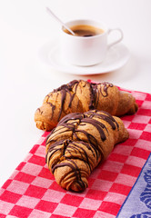 Hot cappuccino and pastries on white wooden boards