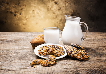 glass of milk and cookie on wooden background