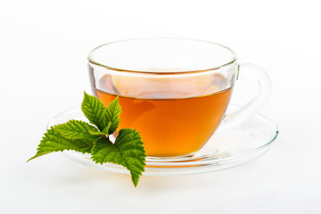 Glass Cup Tea with camomile flower and Mint Leaf, on white
