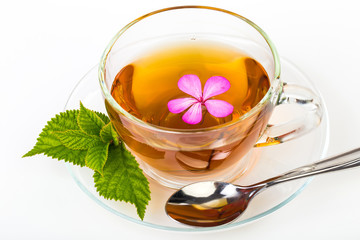Glass Cup Tea with camomile flower and Mint Leaf, on white