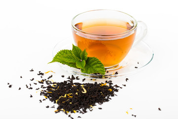 Glass Cup Tea with camomile flower and Mint Leaf, on white