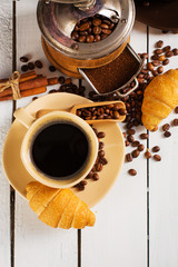 hot coffee and coffee beans on the background of coffee grinders