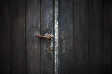 Old wooden entrance door with antique door handle